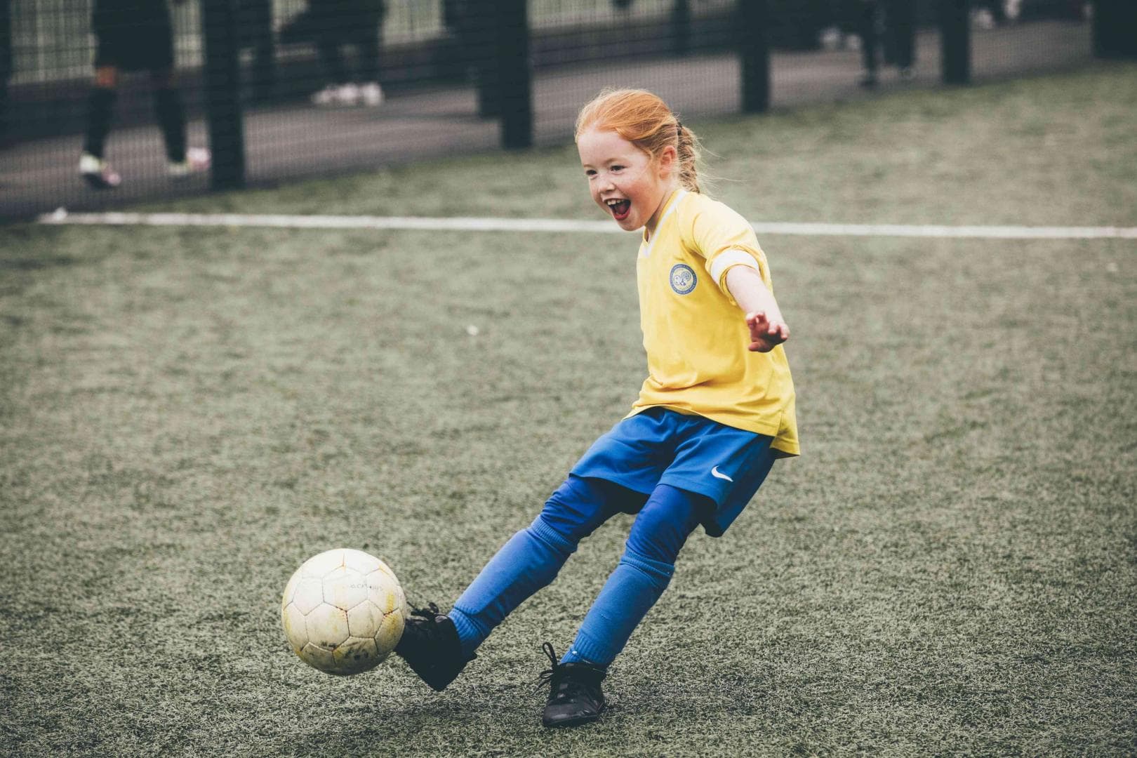 girl playing football grassroots