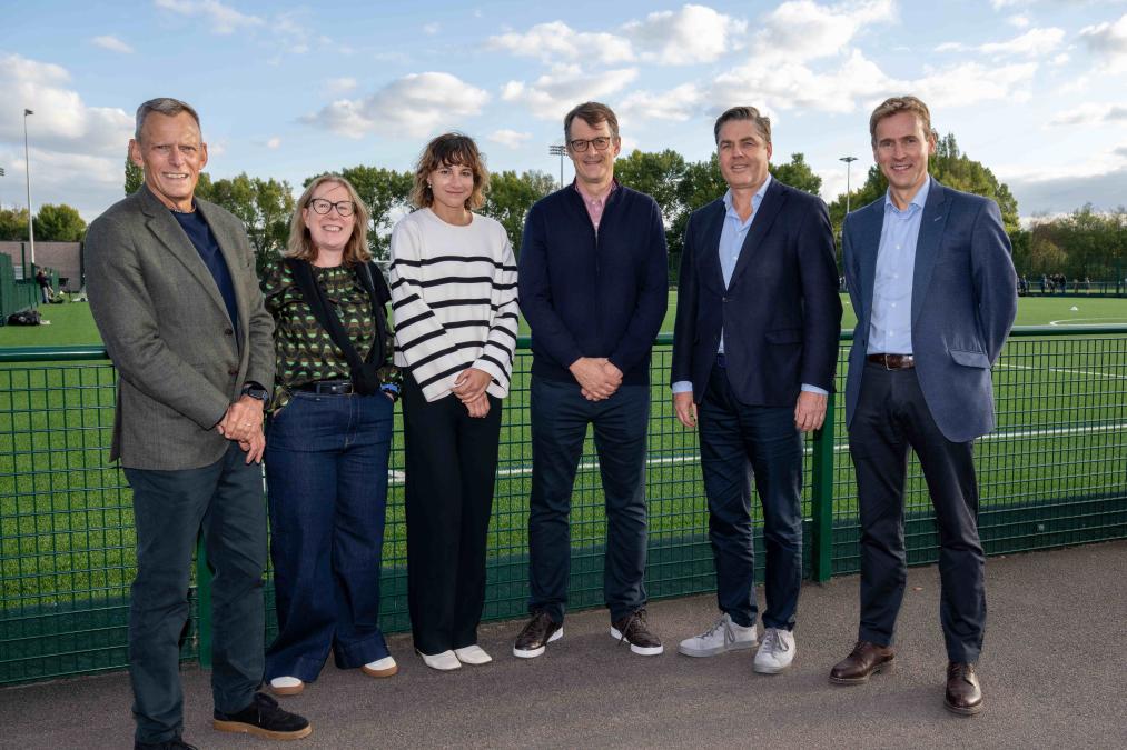 Group of adults stood in front of a 3G pitch