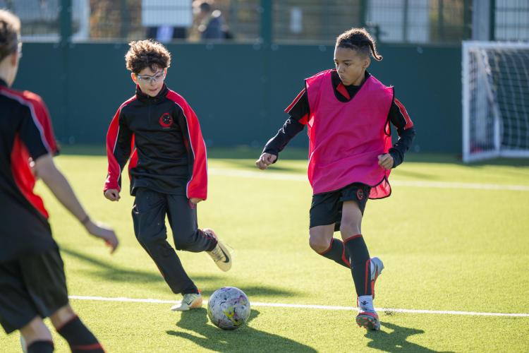 Group of adults stood in front of a 3G pitch
