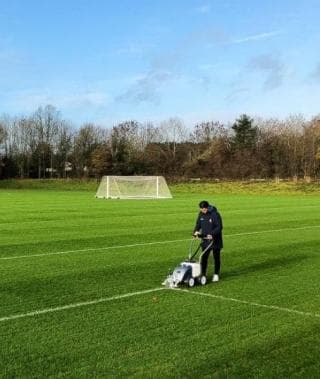 Image of a person maintaining a grass pitch